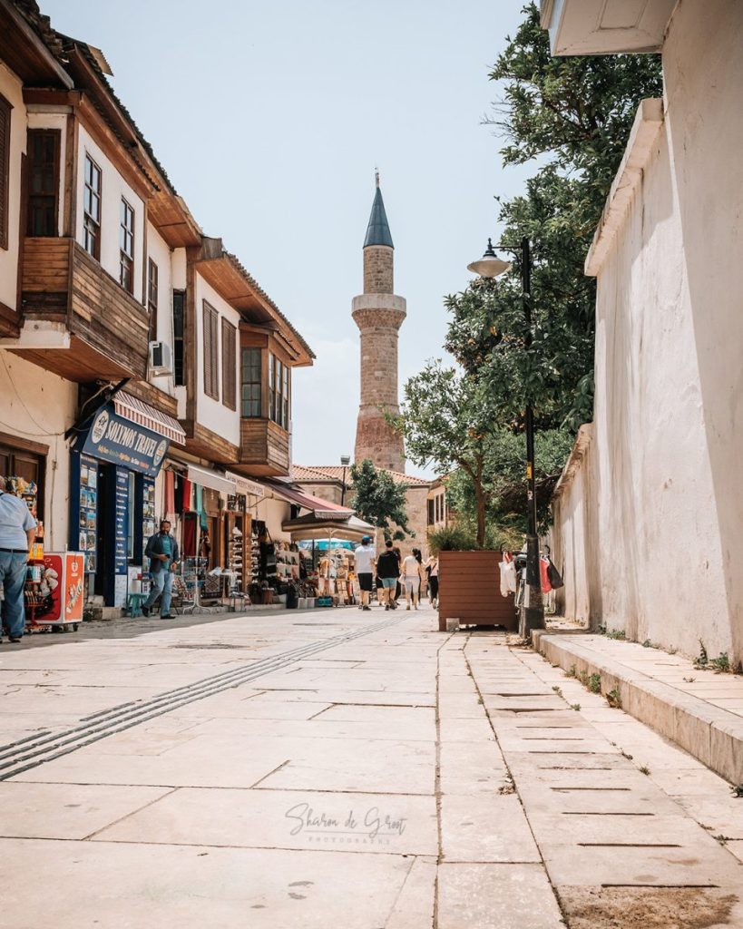 Street in the old city of Antalya with a mosque tower.