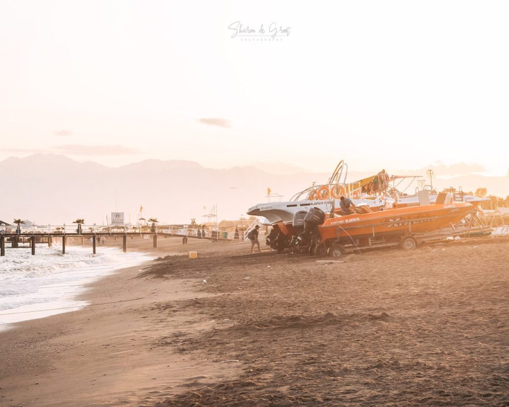 sunny beach with boats on the sand