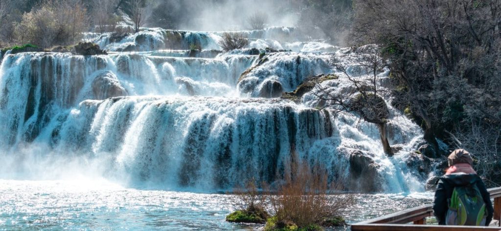 water falls on brown rock formation