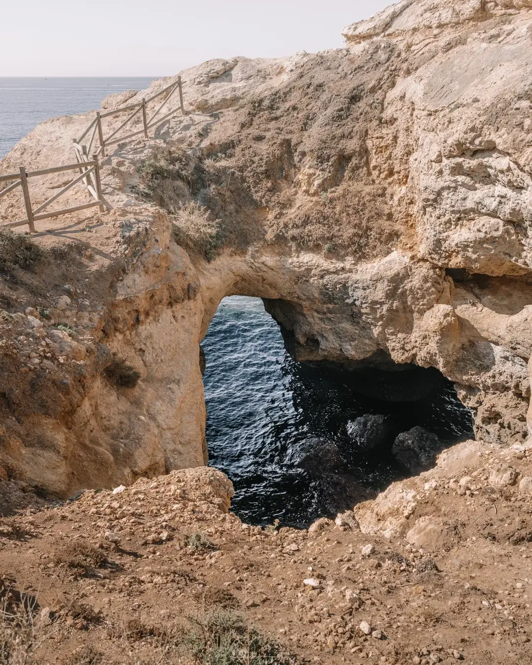 Hole in limestone cliff in the shape of an heart.